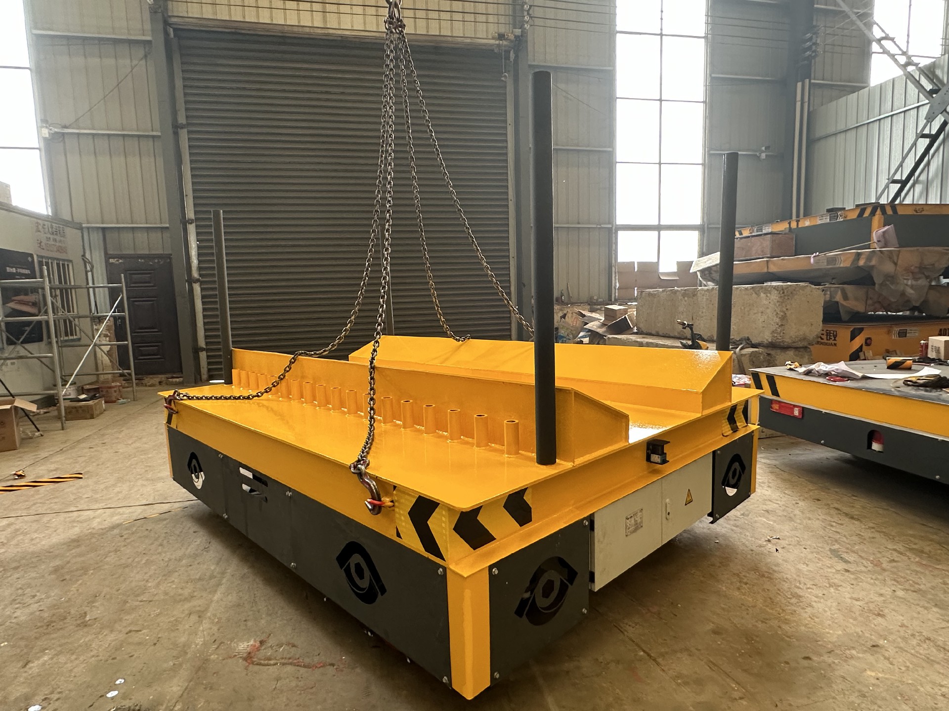 This Electric Coil Transfer Cart is specially designed for transporting steel coils and steel strips. Compared to ordinary trackless carts, its unique features are the platform and the movable steel pipes.  Regardless of the diameter, the distance between the steel pipes can be adjusted to accommodate different diameters of materials, eliminating the need for additional tooling or equipment.